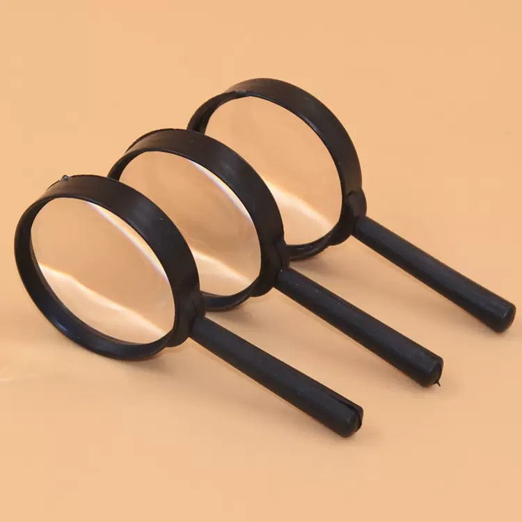 The magnifier held over a printed numbered canvas