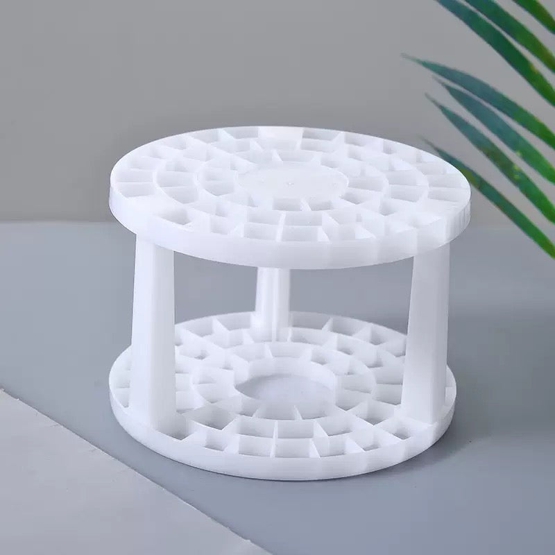 The brush stand seen from above, showing the lattice of holes