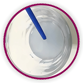 A paint by numbers brush being rinsed in a cup of water