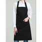 Black bib apron worn over a white shirt