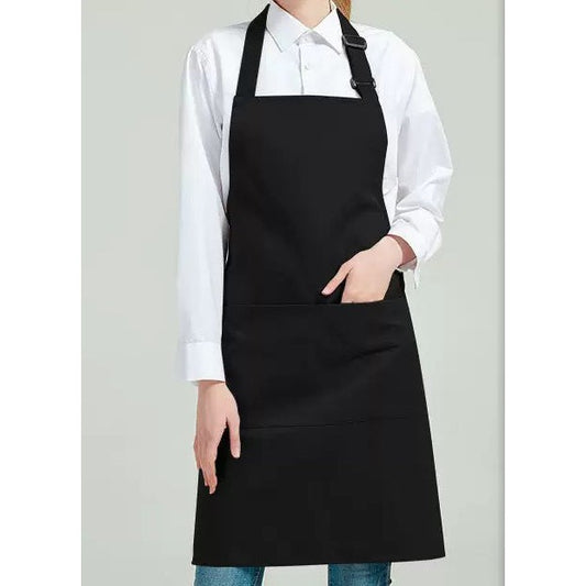 Black bib apron worn over a white shirt