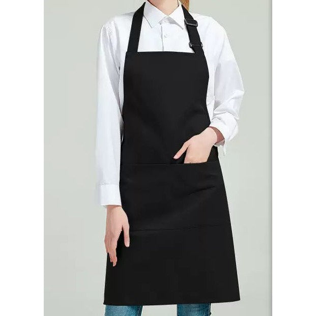 Black bib apron worn over a white shirt