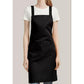 The black apron worn over a T-shirt