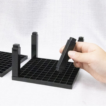 Assembling the rack: posts clip into the black grid base