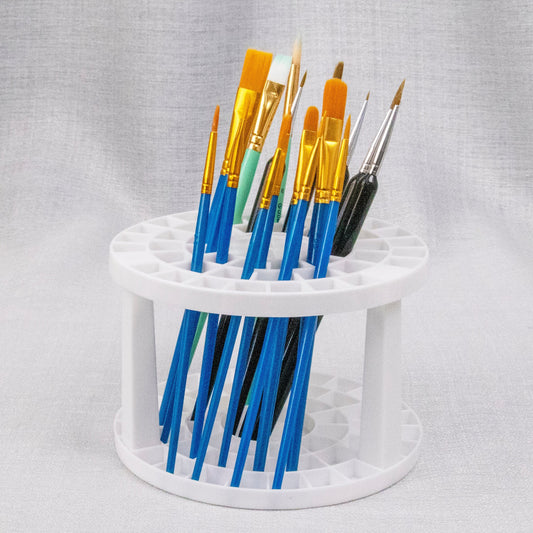 Round white brush stand holding brushes bristle-up