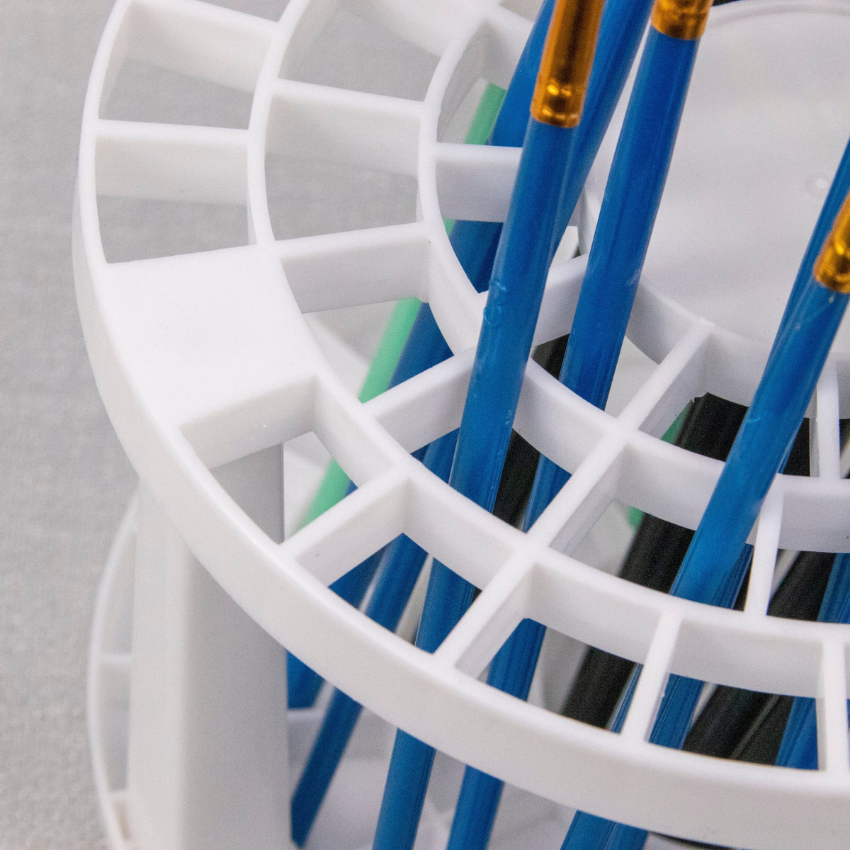 Close-up of brushes standing in the lattice holes