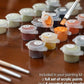 Acrylic paint pots and brushes included in the The Boat's Repose paint by numbers kit