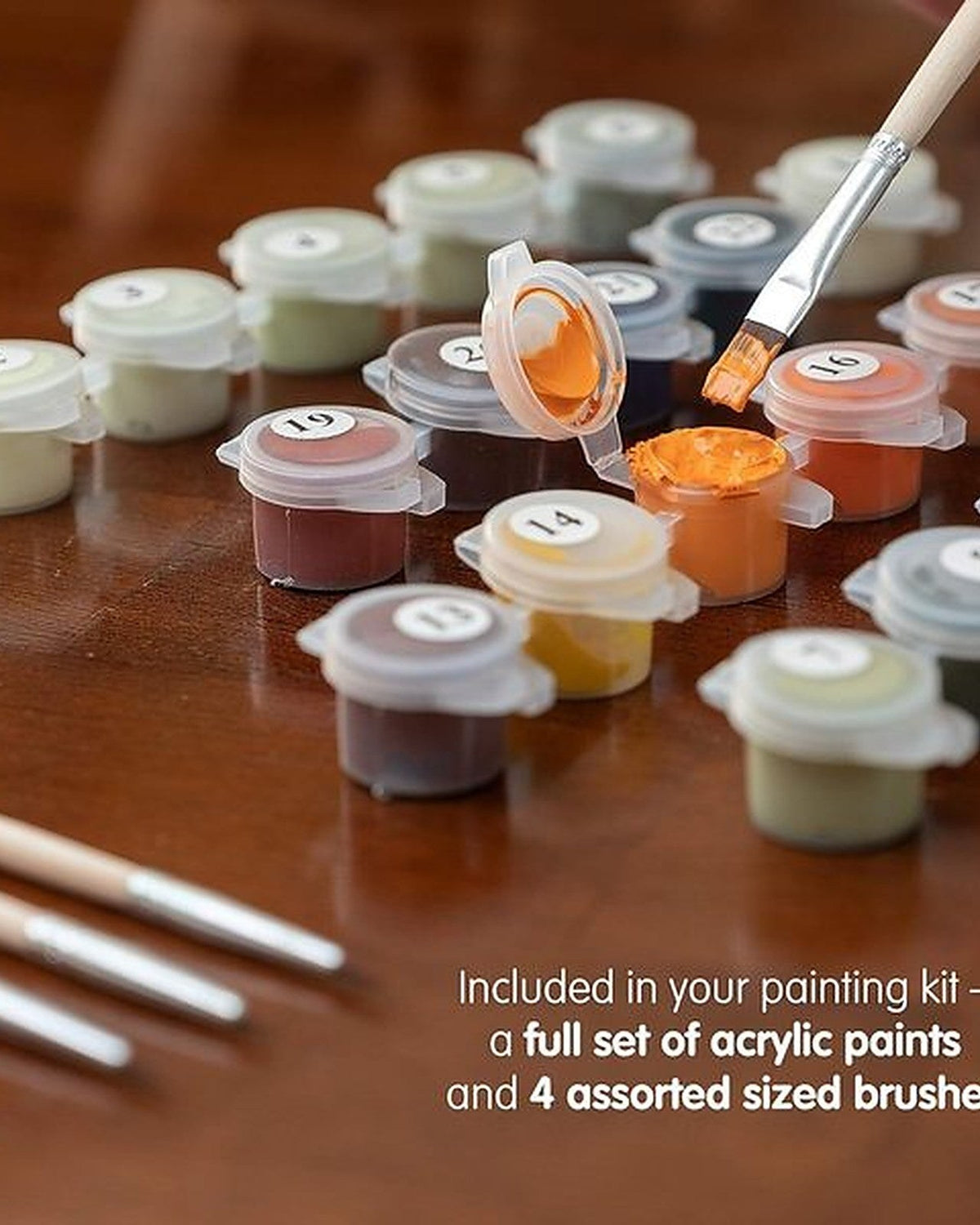 Acrylic paint pots and brushes included in the Cosmic Watercolors paint by numbers kit