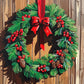 green christmas wreath with red berries, pine cones and a red ribbon on a wooden door, paint by numbers kit