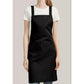 The black apron worn over a T-shirt